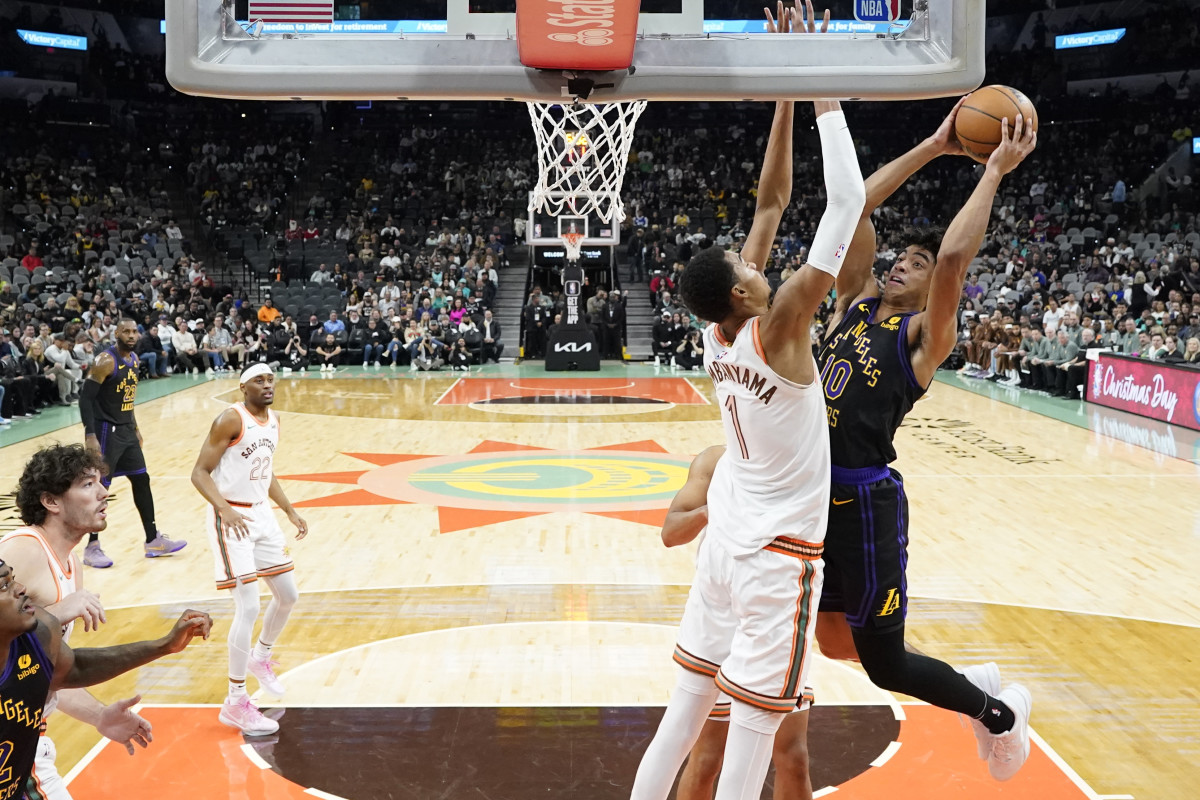 Dec 15, 2023; San Antonio, Texas, USA; Los Angeles Lakers guard Max Christie (10) shoots over San Antonio Spurs forward Victor Wembanyama (1) during the first half at Frost Bank Center.